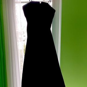 Strapless black velvet formal dress with rhinestone trim at border of bodice.